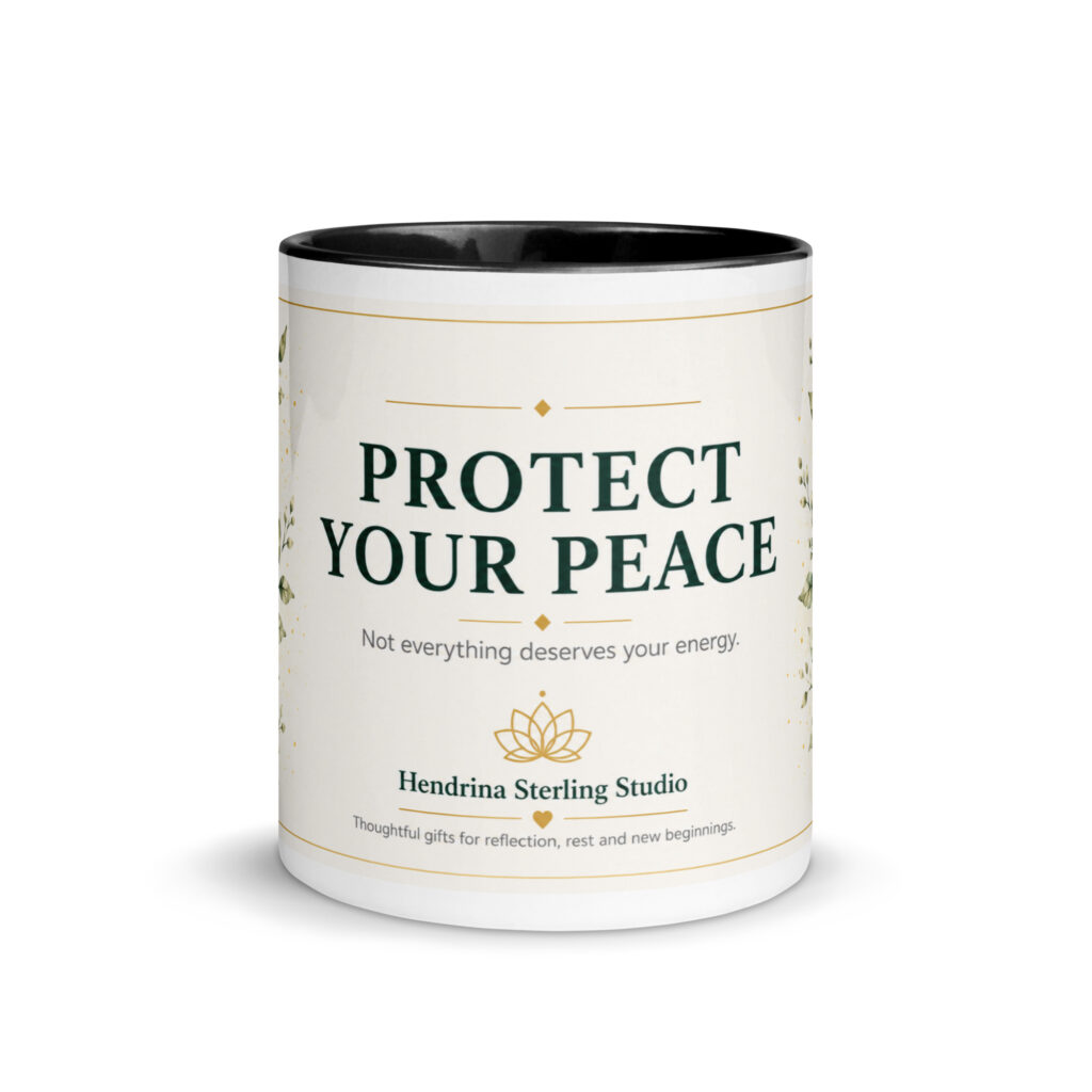 White ceramic mug with a colorful interior and handle, printed with the Protect Your Peace design in black script lettering